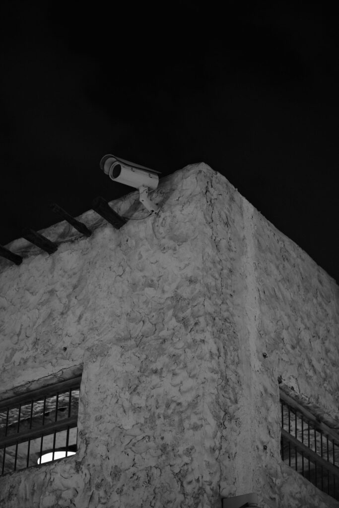 Security camera watching a building at night to deter crime