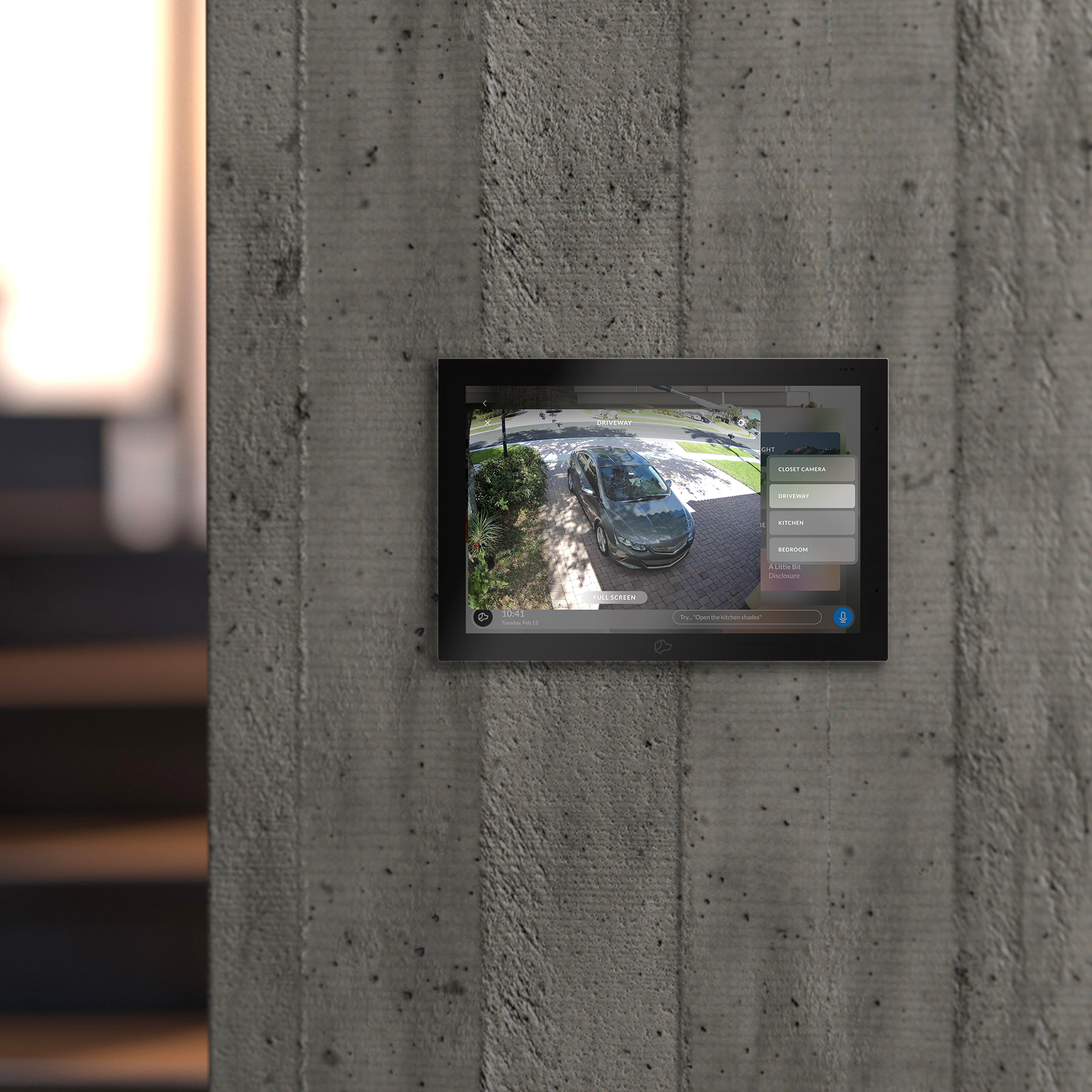 Josh.ai touchscreen flush-mounted in a concrete wall, showing the home control interface
