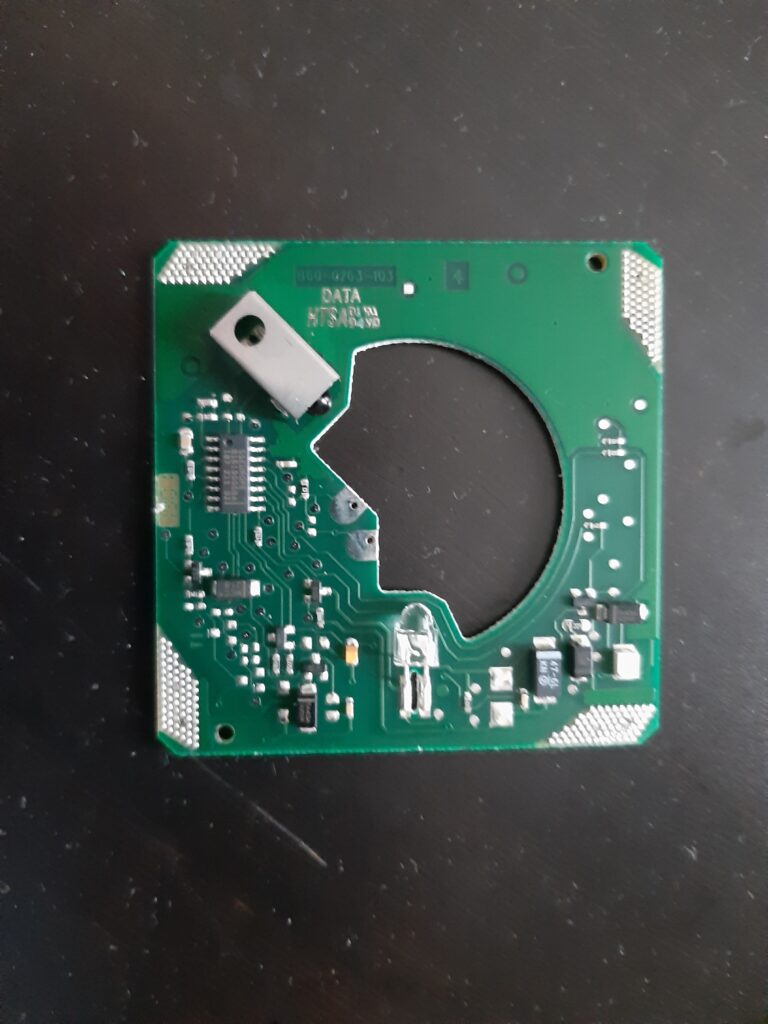 Testing a home security smoke detector during maintenance