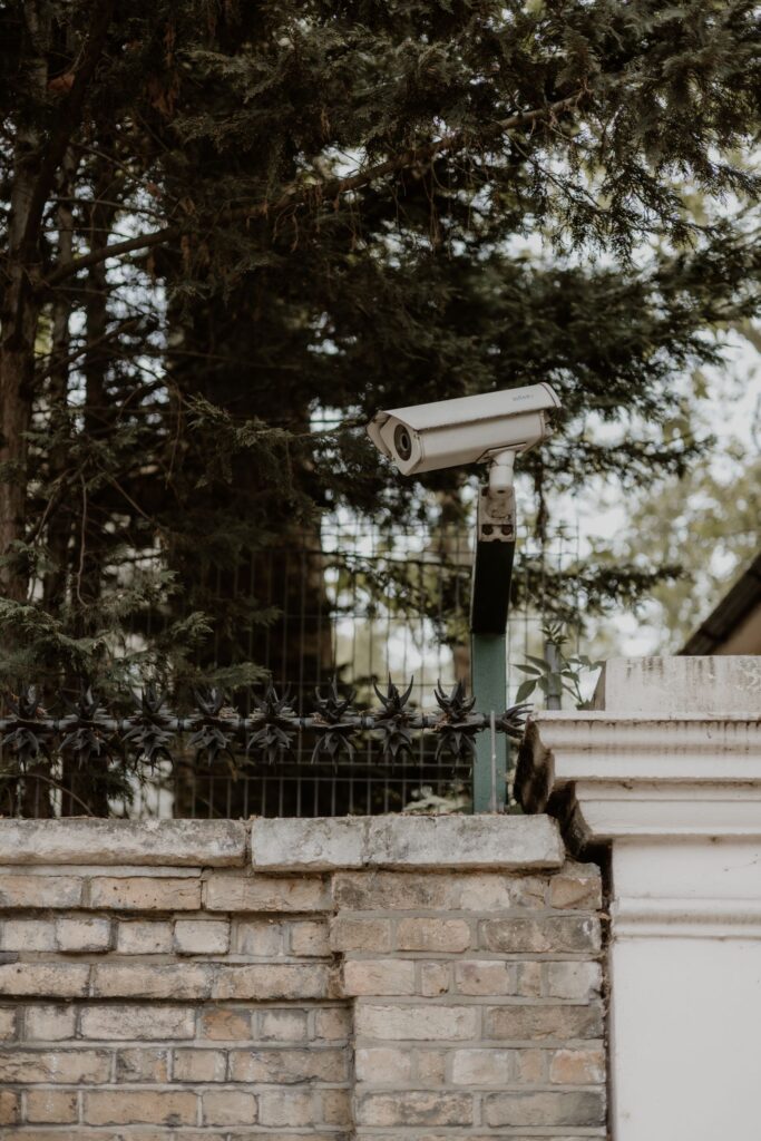 Outdoor home security camera mounted on a wall covering a residential property